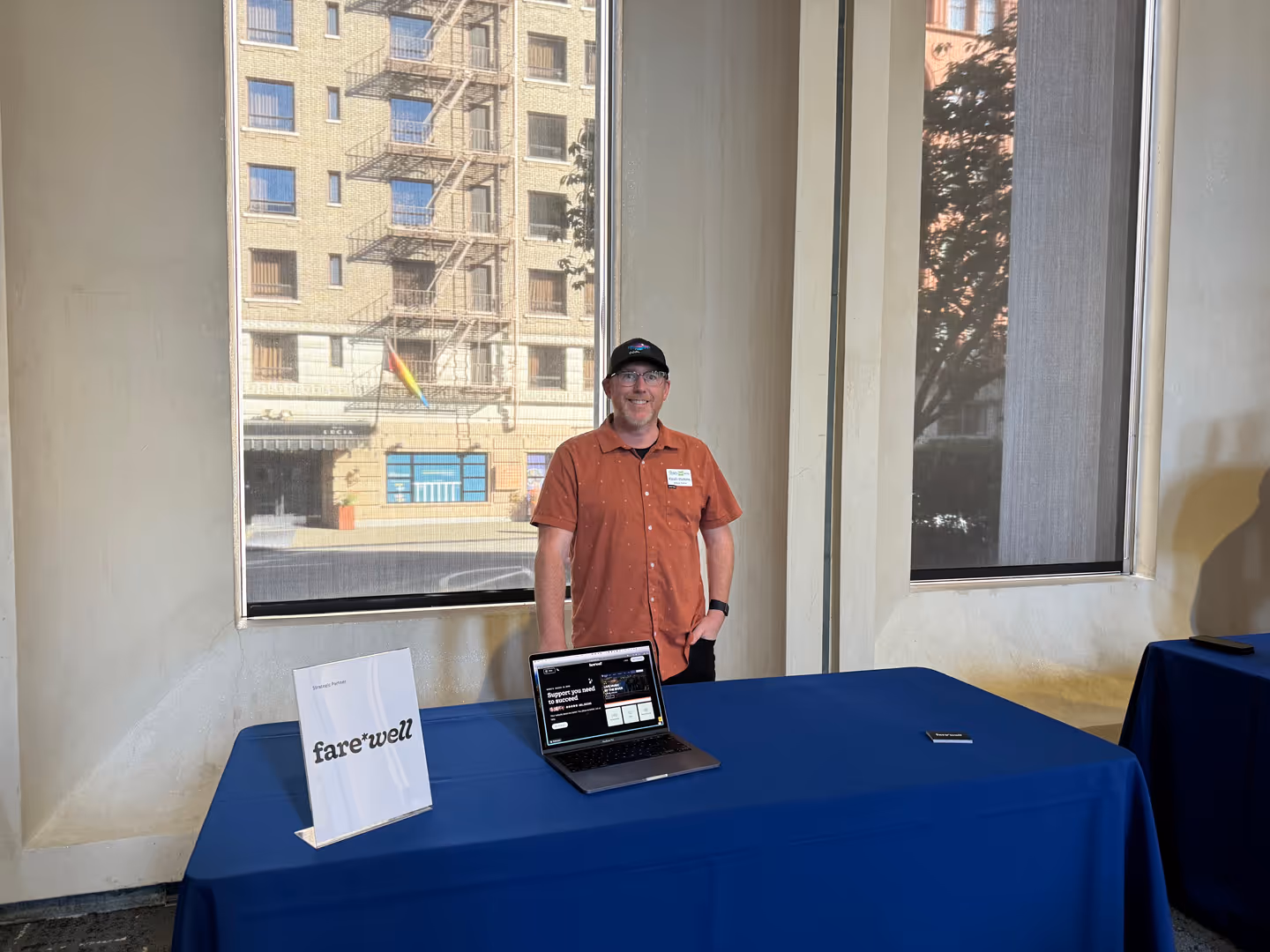 A teammate at a fare·well booth with a laptop