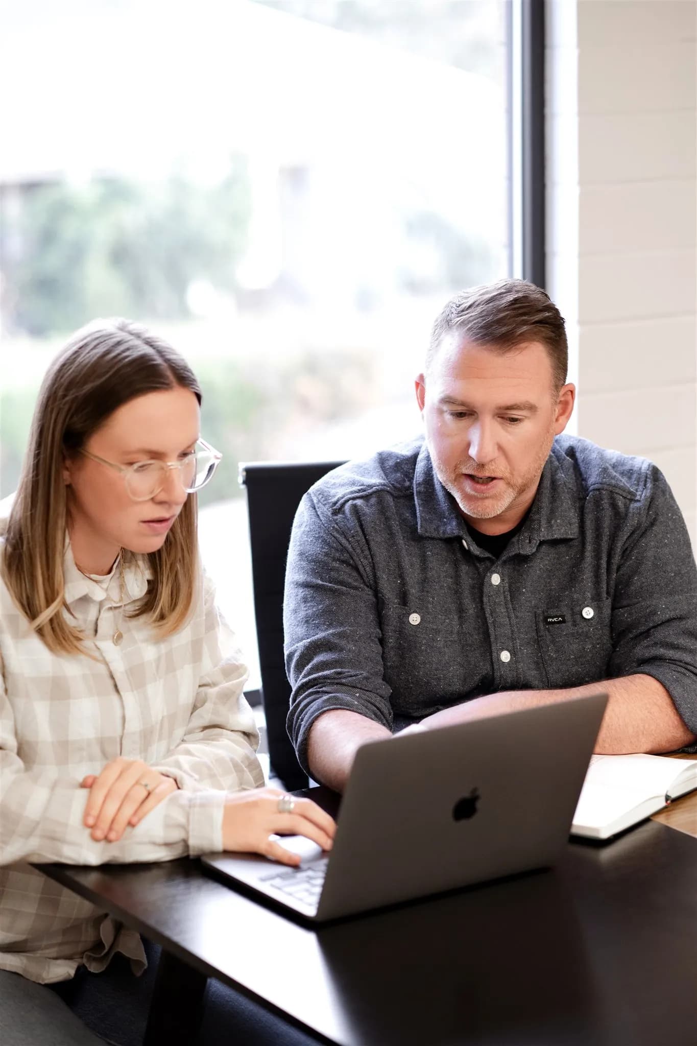 Two Webflow developers reviewing the latest trends in web design.