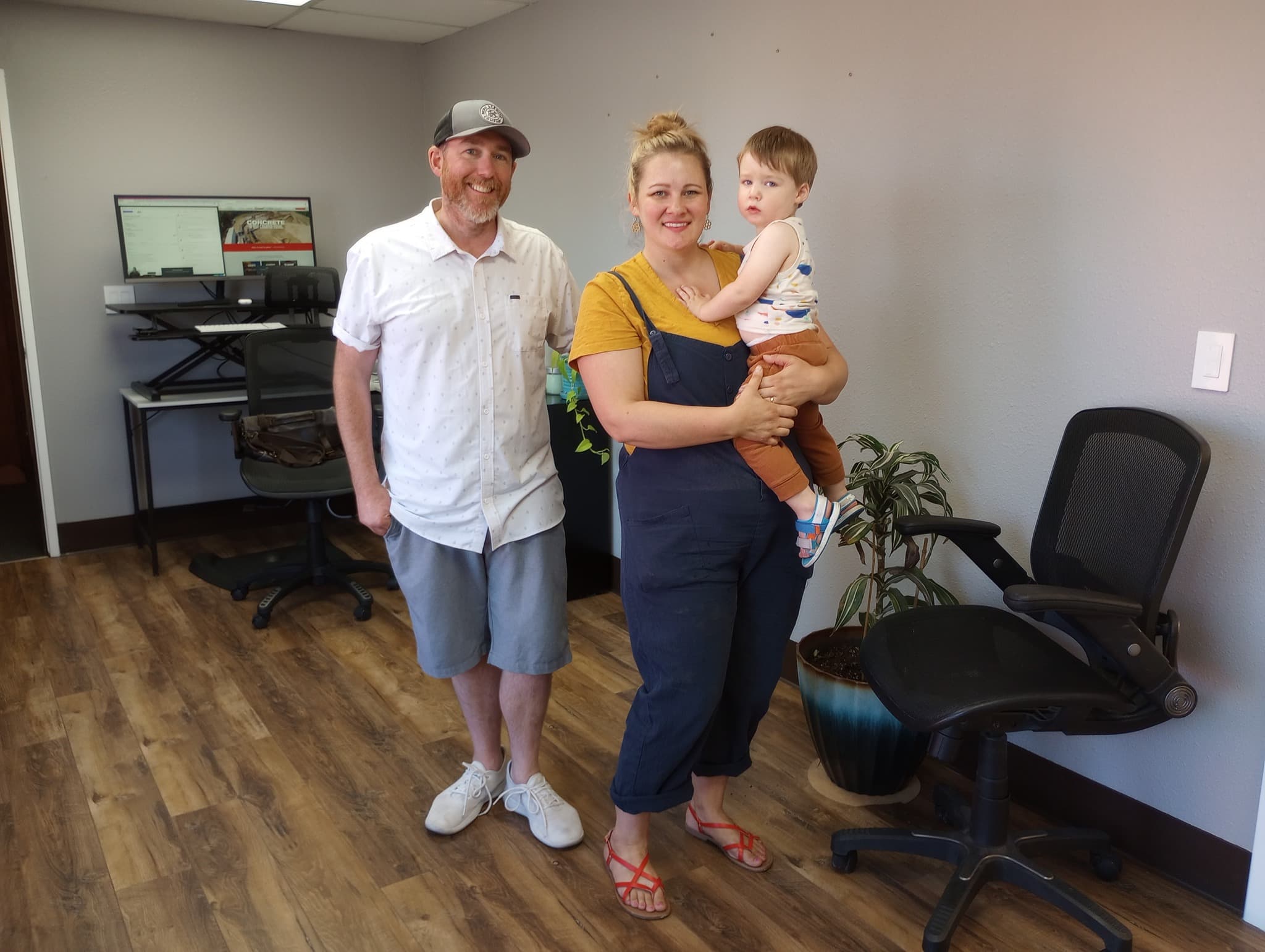 Kevin with his wife and kid in the office.
